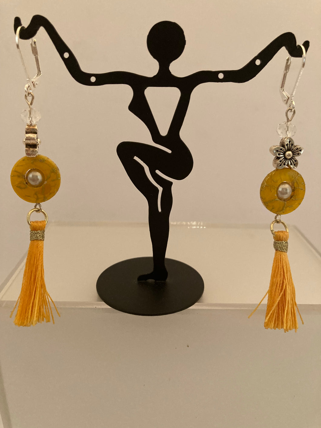 Long tassles with yellow ring bead and flower charm