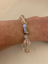 Load image into Gallery viewer, Glass faceted pale pink and clear opal beaded stretch bracelet, with matching earrings.
