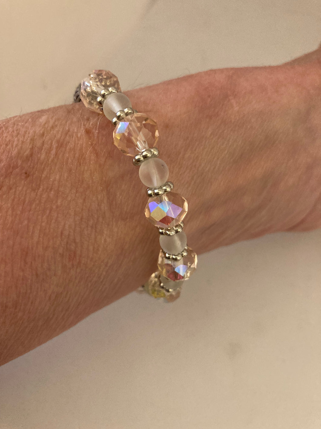 Glass faceted pale pink and clear opal beaded stretch bracelet, with matching earrings.