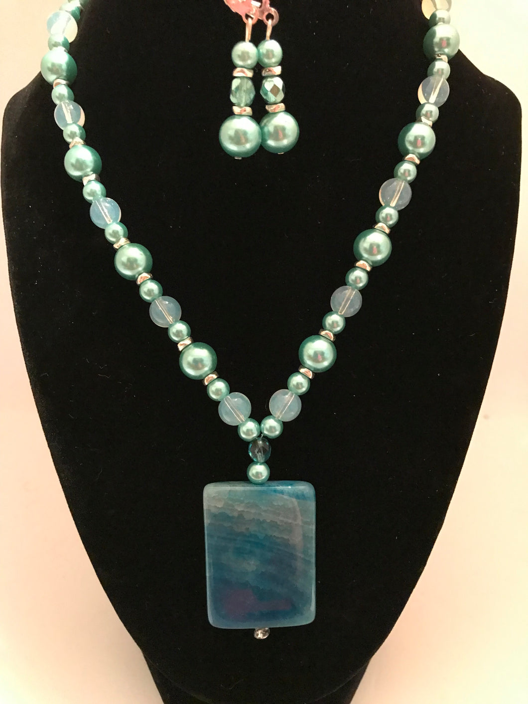 Novelty rectangular ocean blue pendant with soft blue pearl beads, and matching earrings