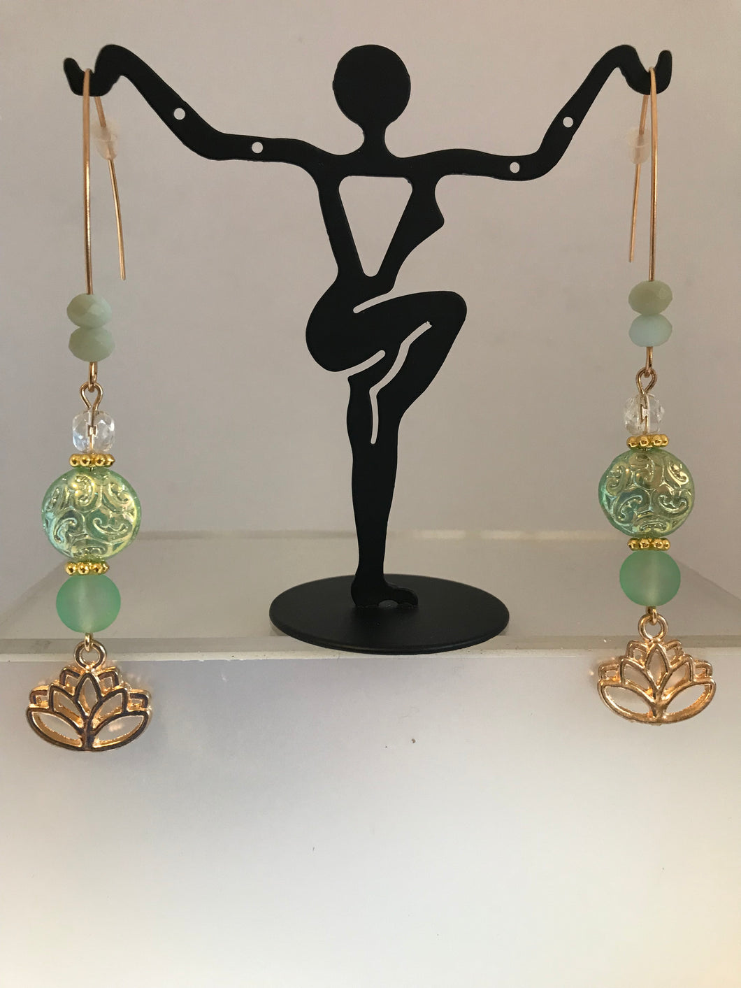 Lotus charms with assorted sage green beads and earlobe wires.