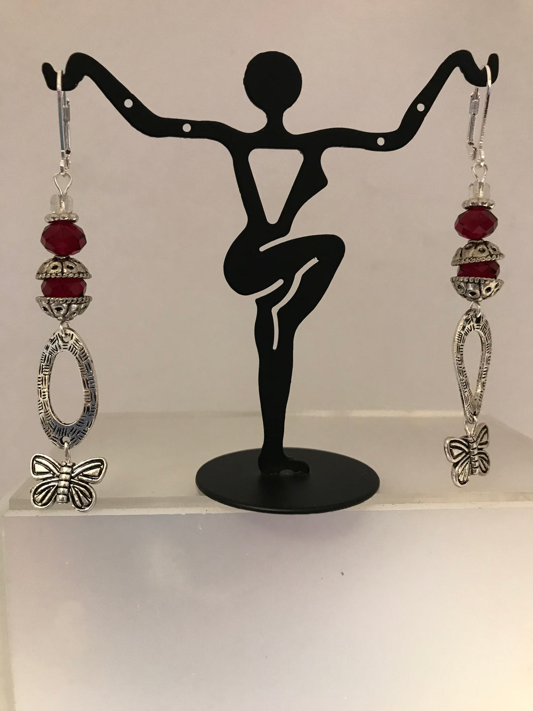 Dangling butterfly charms with ruby red bead earrings