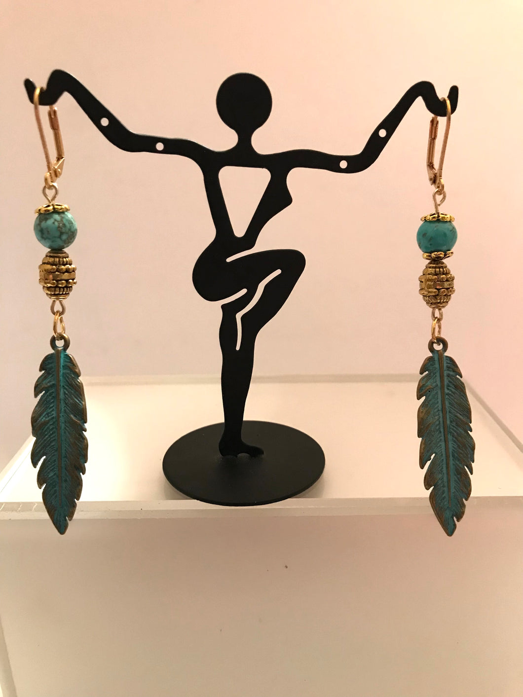 Feather earrings with gold and turq beads.